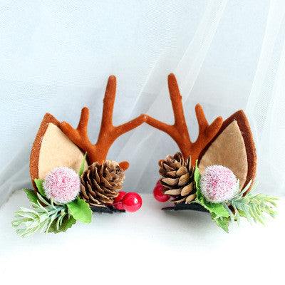 Children's Christmas hair clip with fabric reindeer antlers, pine cones, and festive decorations