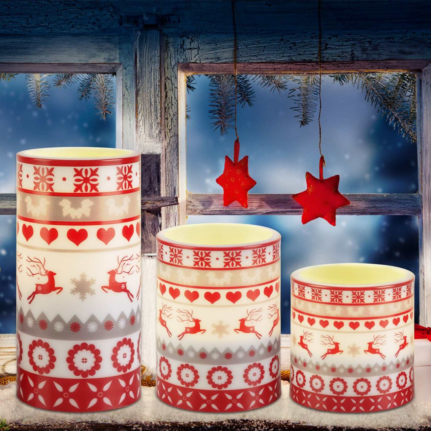 Christmas flameless LED candles decorated with reindeer, hearts, and snowflakes in a winter setting.