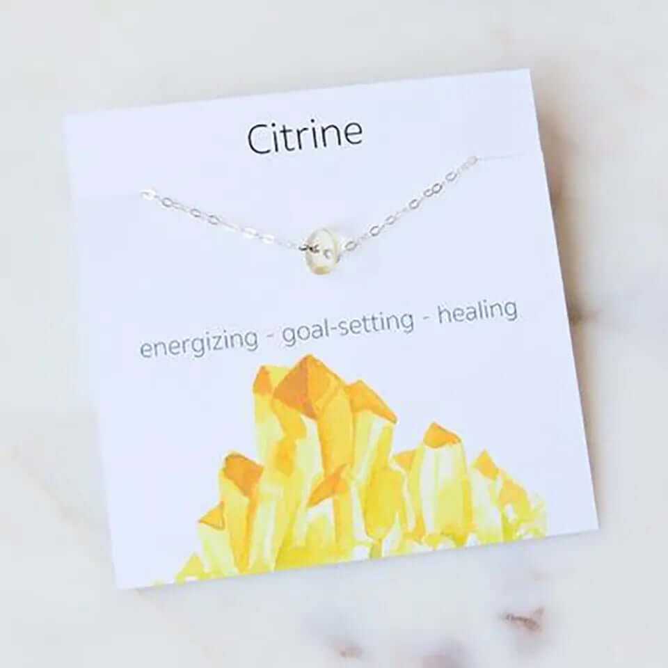 Citrine necklace on display card, highlighting energizing, goal-setting, and healing properties.