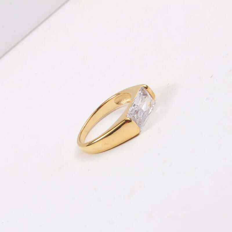 Elegant 18K gold plated ring with a radiant clear gemstone, showcasing classic dainty style.