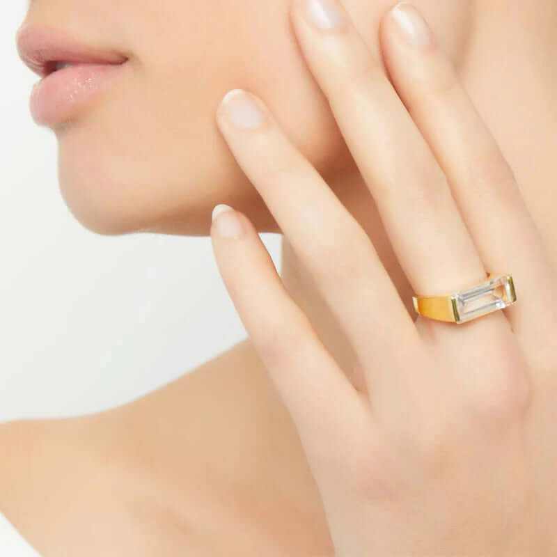 Close-up of a woman wearing a Classic Dainty Elegant 18K Gold Plated Ring with a clear stone, showcasing refined style and elegance.