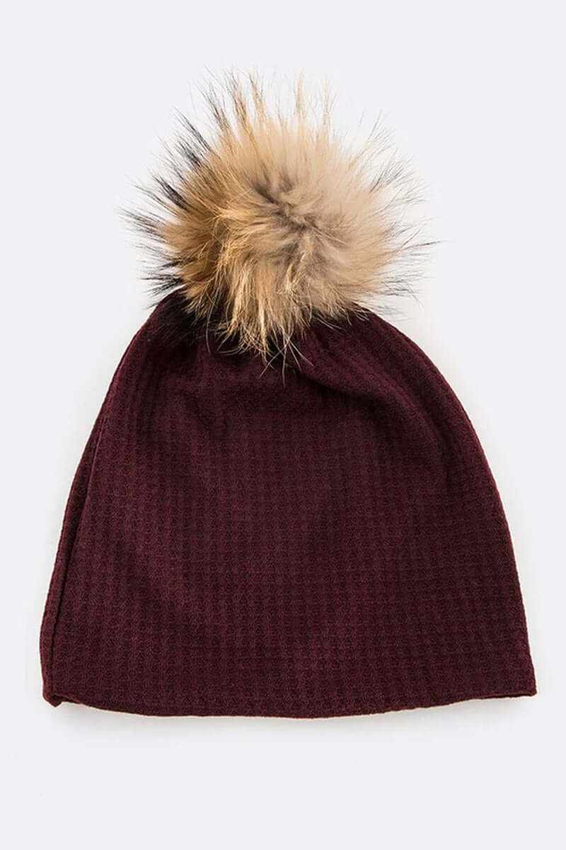Cotton slouchy beanie in burgundy with faux fur pom for stylish warmth and comfort during cold weather.