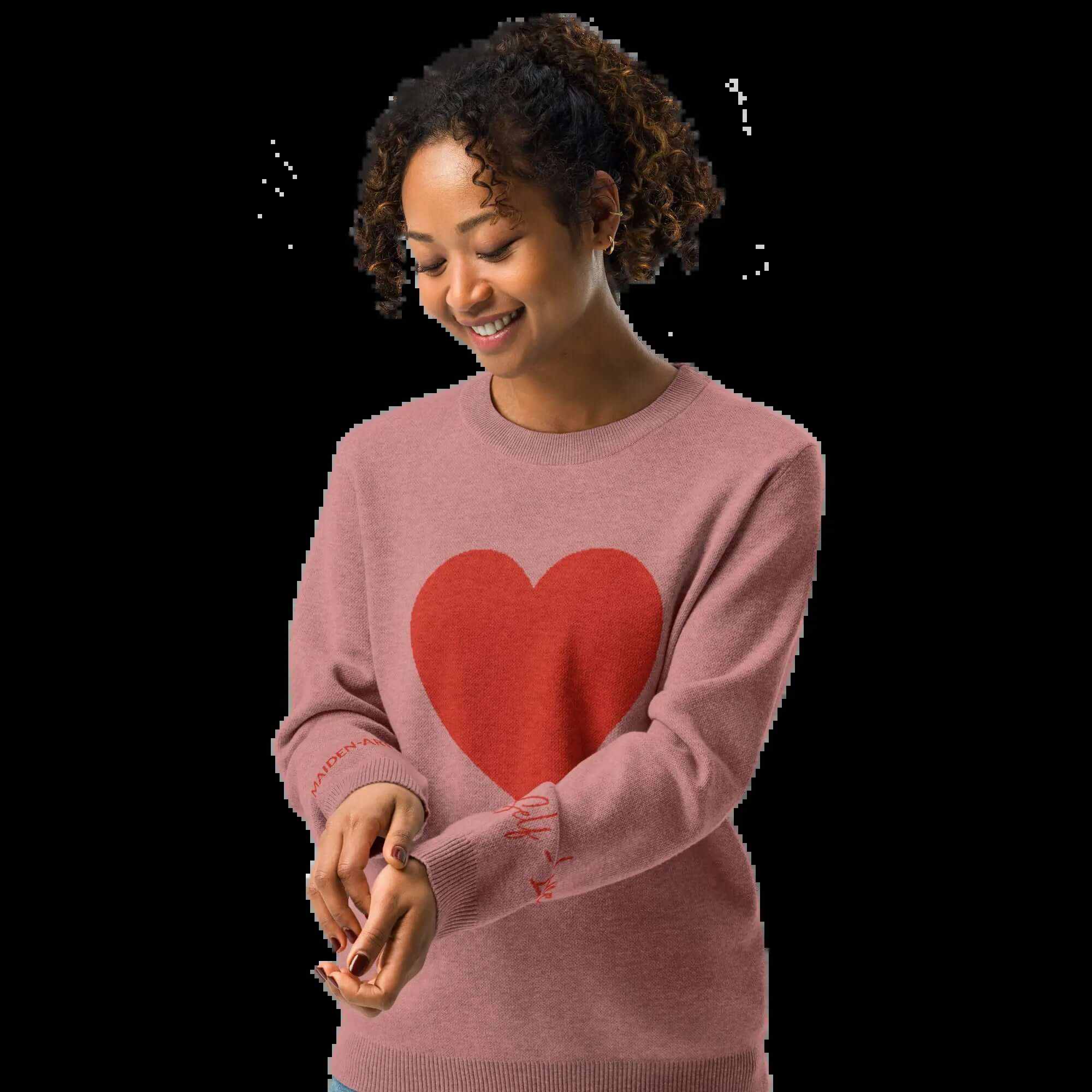 Model wearing a cozy coral heart knit crewneck sweater, showcasing a soft and warm design with a heart graphic.