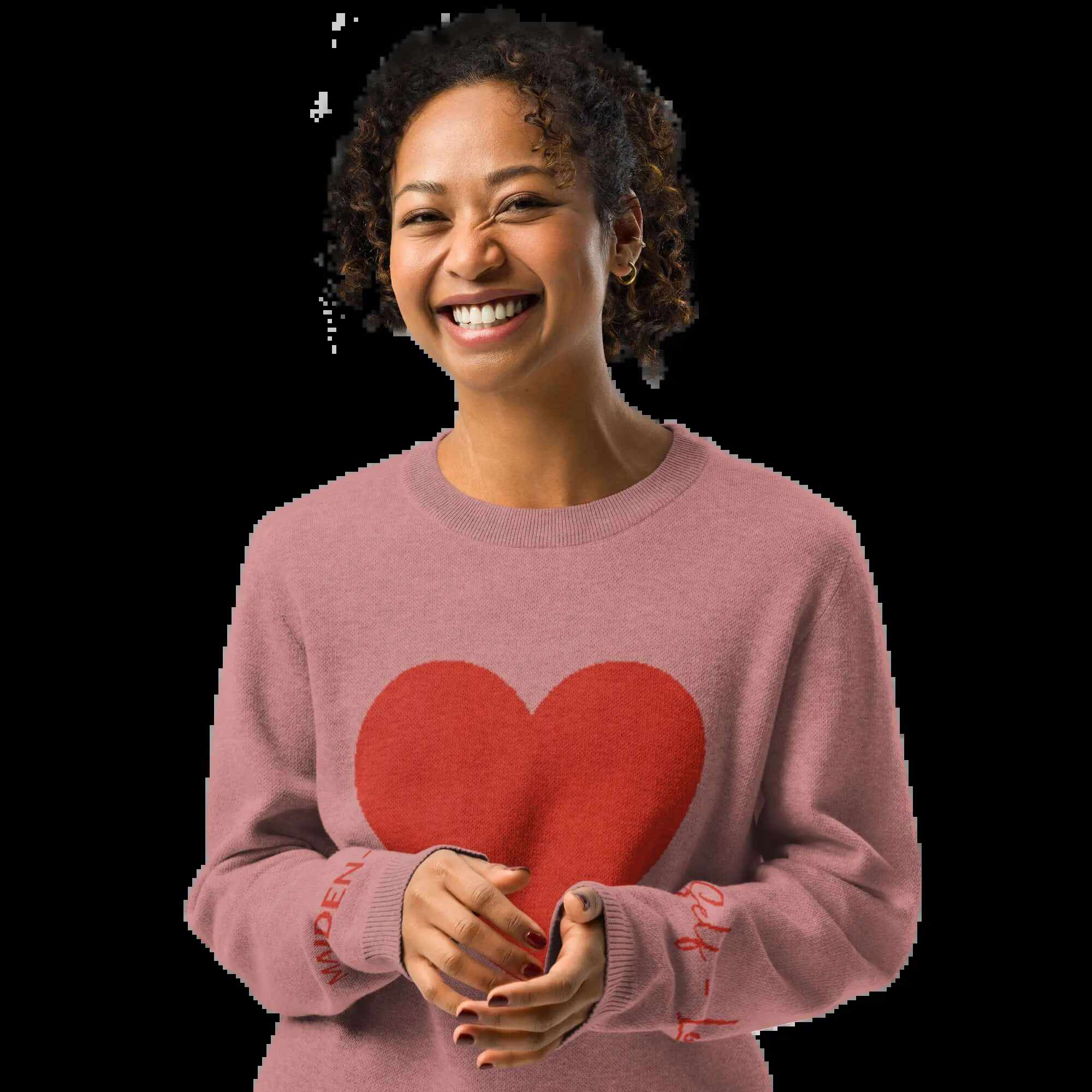 Smiling woman wearing a cozy coral heart knit crewneck sweater, perfect for a warm and stylish outfit.