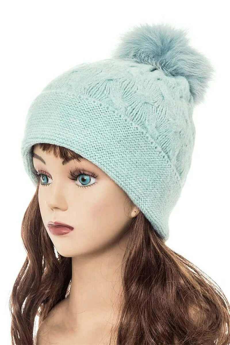 Light blue cuffed slouchy beanie with fur pom, perfect for winter style and warmth.