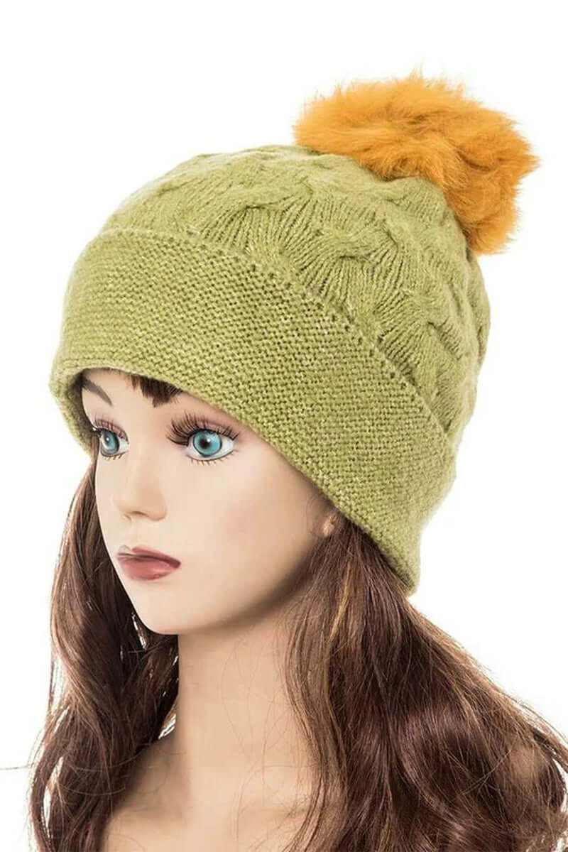 Cuffed slouchy beanie in olive green with fur pom, showcasing cozy knit texture for stylish winter warmth.