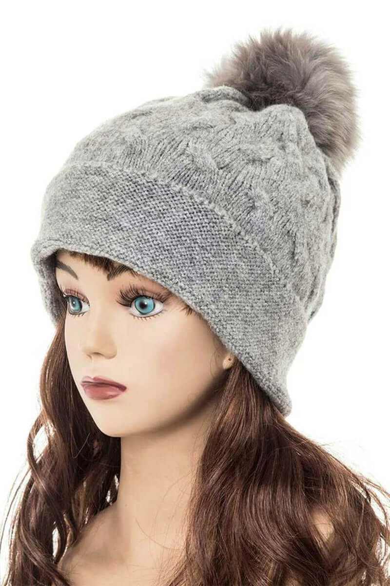 Cuffed slouchy beanie with fur pom in gray, perfect for stylish warmth this winter season.