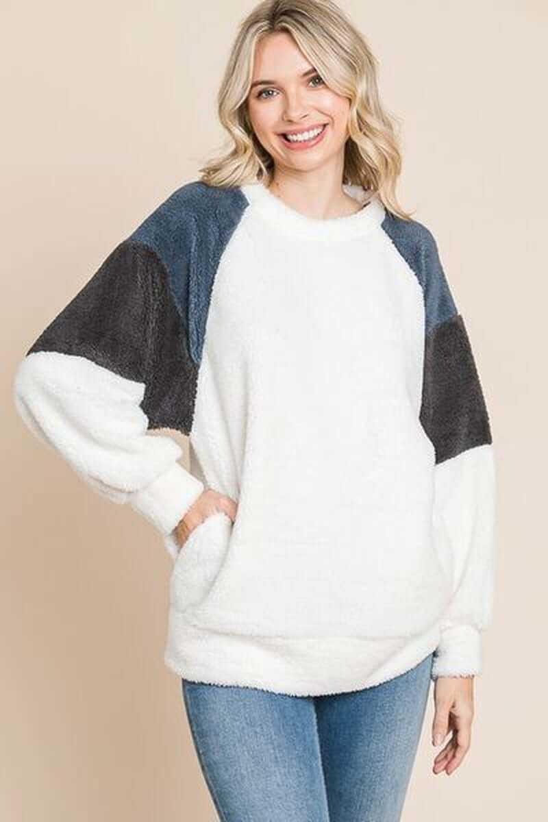 Model wearing Culture Code Color Block Faux Fur Raglan Sleeve Sweatshirt with multicolored sleeves and cozy texture.