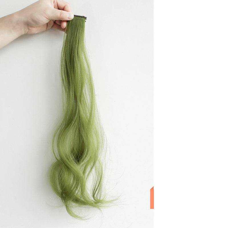 Hand holding long green hanging ear dyed curly hair extension