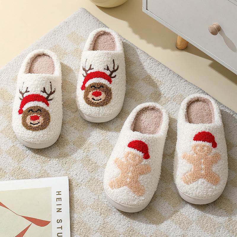 Cozy cute cartoon Santa Claus slippers with reindeer and gingerbread designs on soft white fleece material