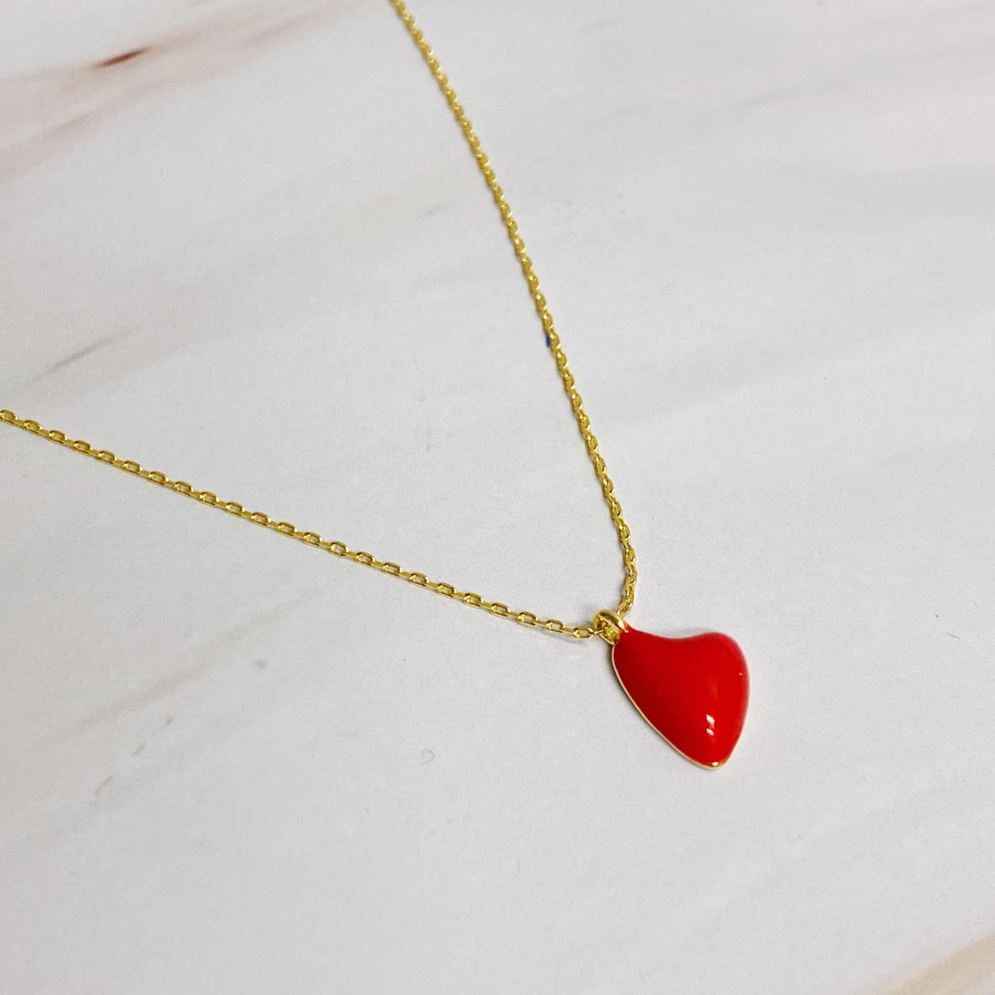 Cute colorful heart pendant necklace featuring a red heart on a gold chain, perfect for everyday wear.