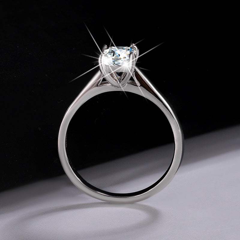 D Color 1 Carat Moissanite Ring with sparkling stone and silver band on dark background