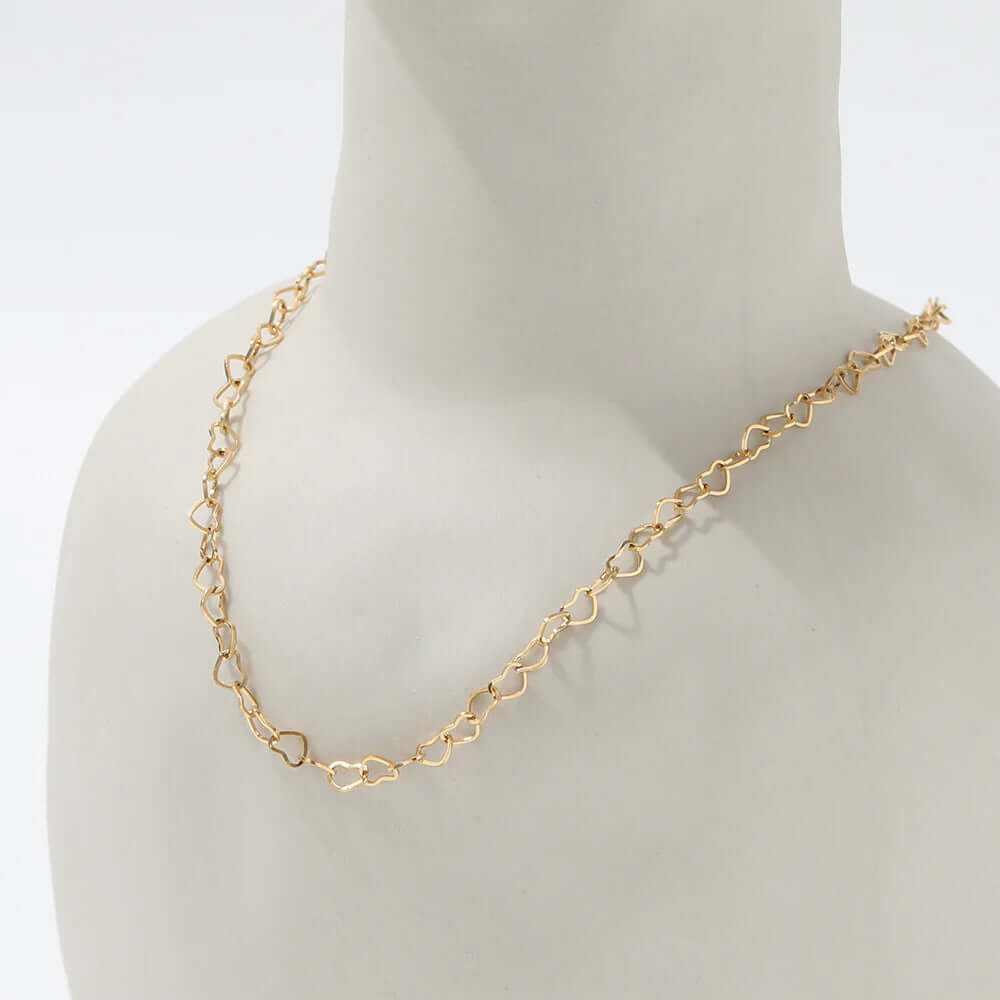 Dainty hollow heart choker necklace in gold-plated finish displayed on a mannequin bust.