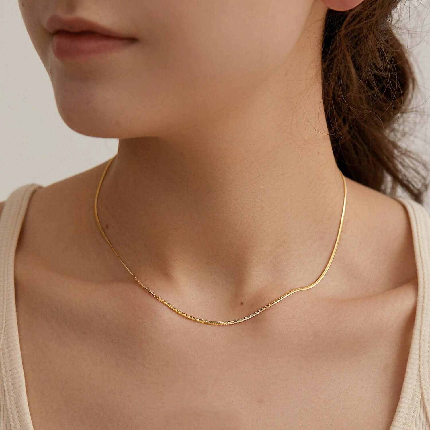Dainty trendy layered gold plated choker necklace showcasing elegant craftsmanship worn around the neck.