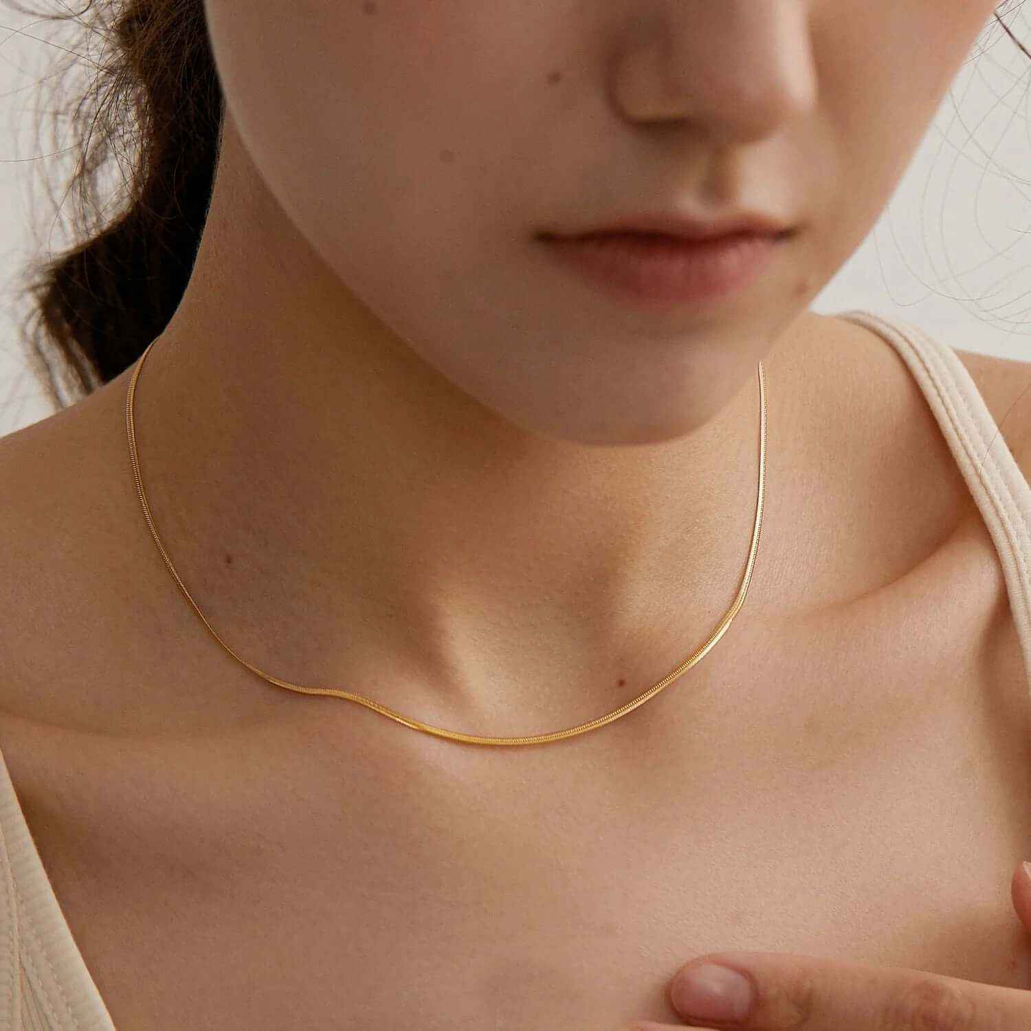 Layered gold plated choker necklace elegantly worn, showcasing its refined and trendy design.
