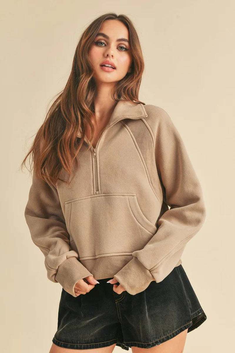 Dove Funnel Neck Half Zip sweater in soft beige, styled with a cozy oversized fit and half-zip design, perfect for casual wear.