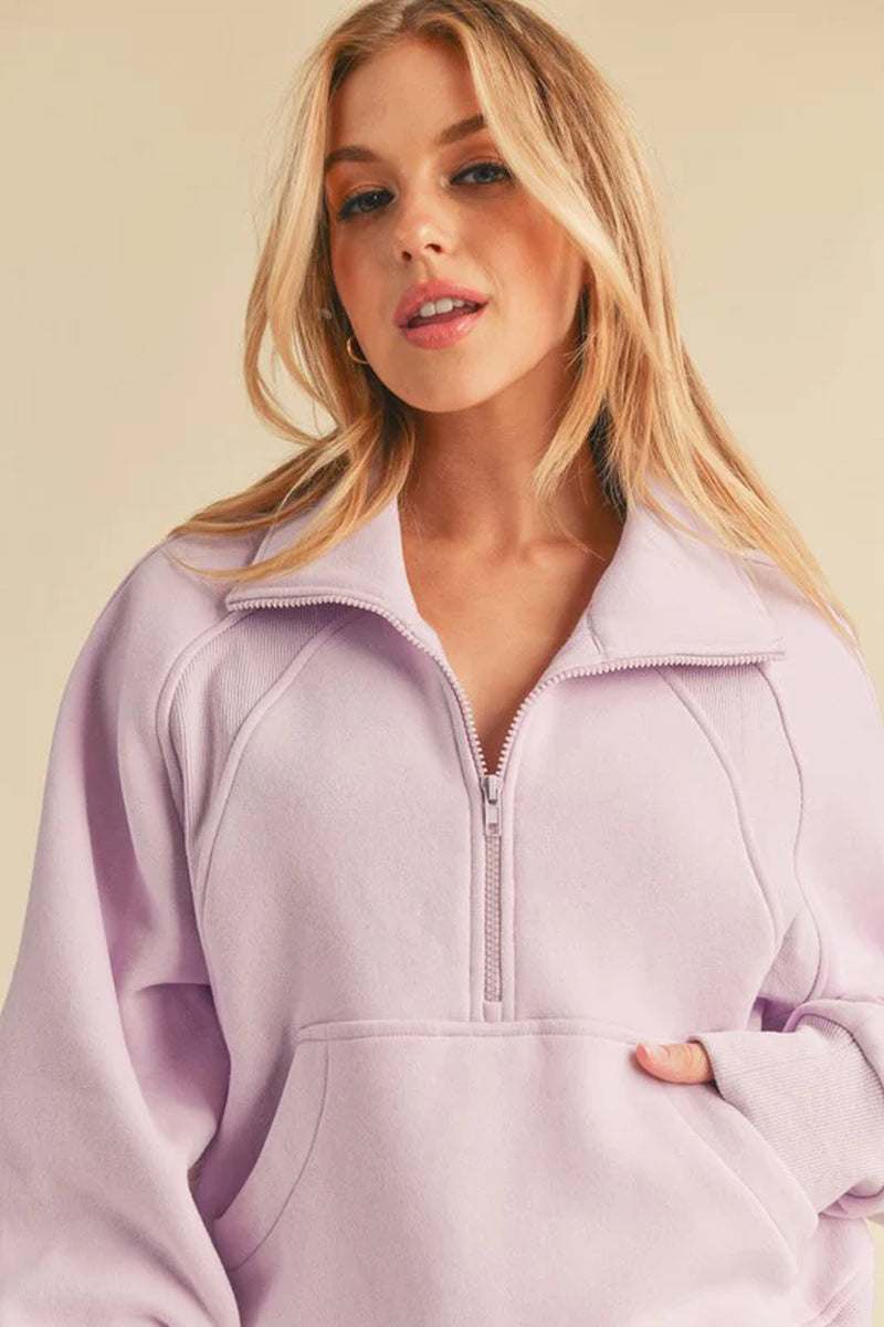 Dove Funnel Neck Half Zip sweater in soft lavender worn by a model, showcasing oversized fit and cozy funnel neck style.