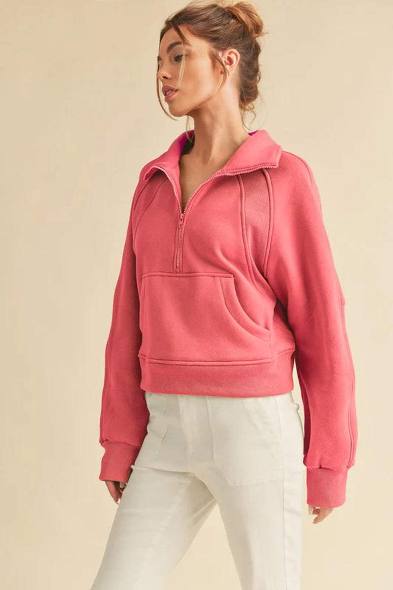 Dove Funnel Neck Half Zip sweater in pink on model, showcasing cozy oversized fit and stylish half-zip design.