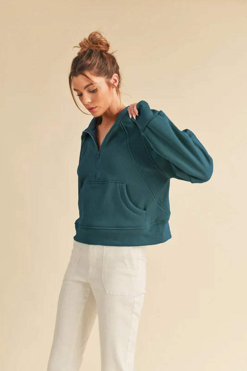 Dove half-zip sweater in teal, featuring a cozy funnel neck and oversized fit, perfect for year-round comfort and style.