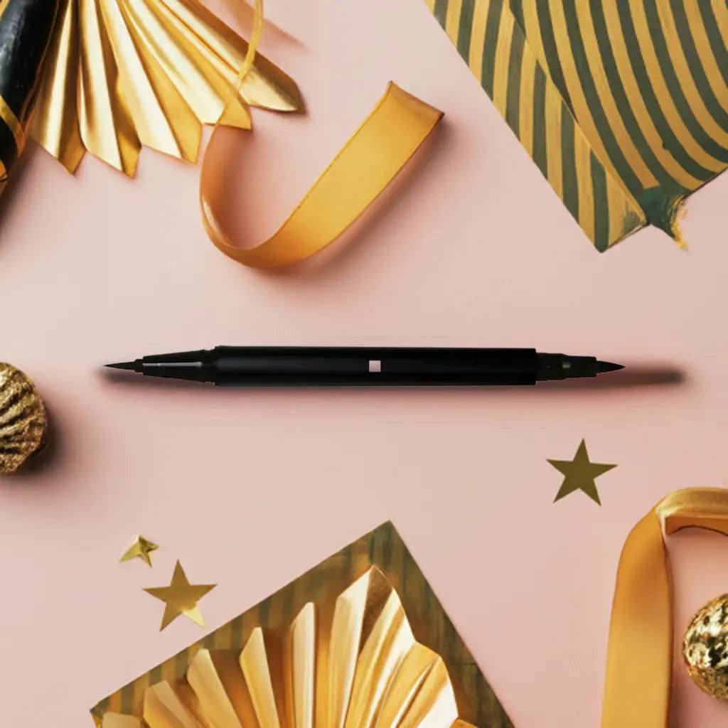 Dual Tip Precision Eye Definer Makeup Pen on a pink background with decorative elements, showcasing its two fine tips.
