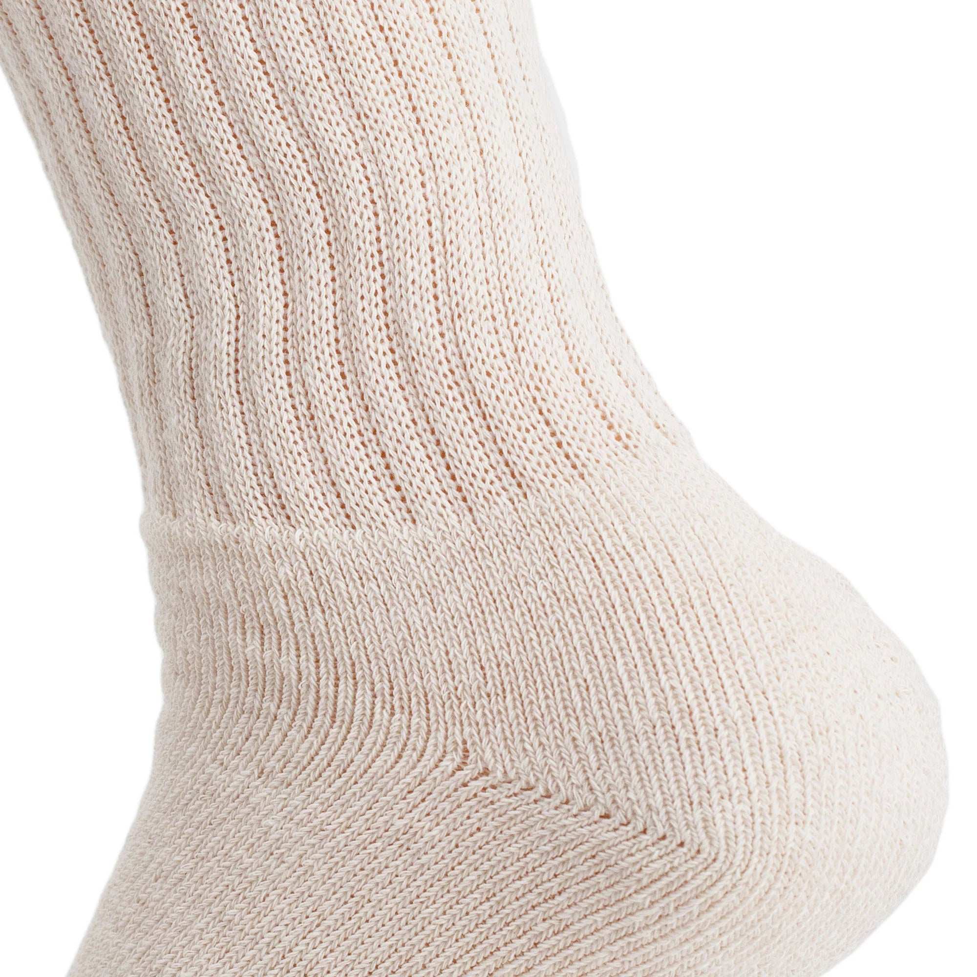 Close-up of ecru cotton crew sock for women, showcasing ribbed texture and cushioned sole.