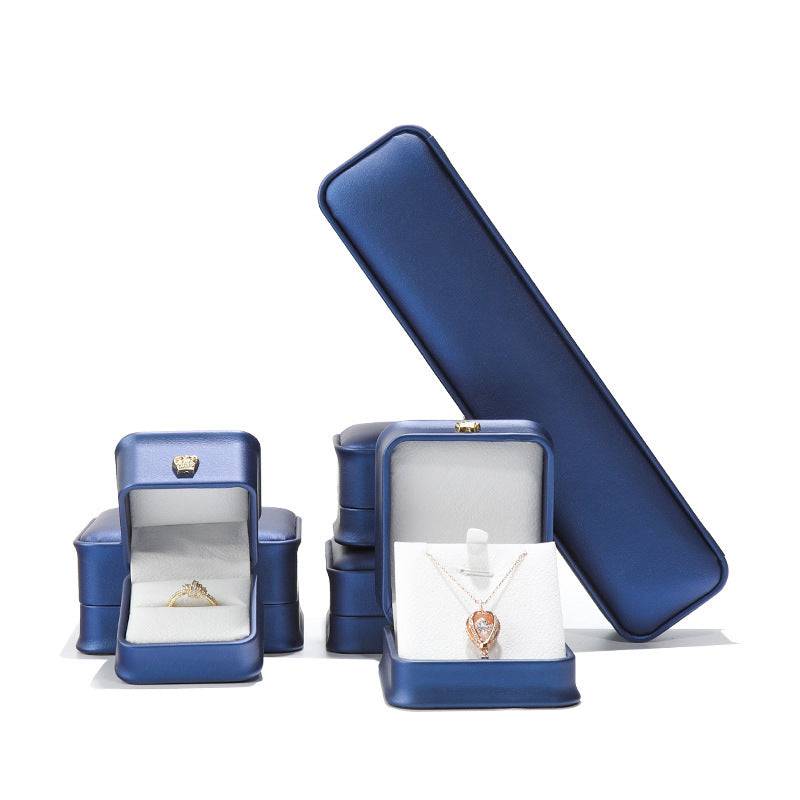 Elegant blue jewelry display cases for rings and necklaces showcasing luxury packaging.