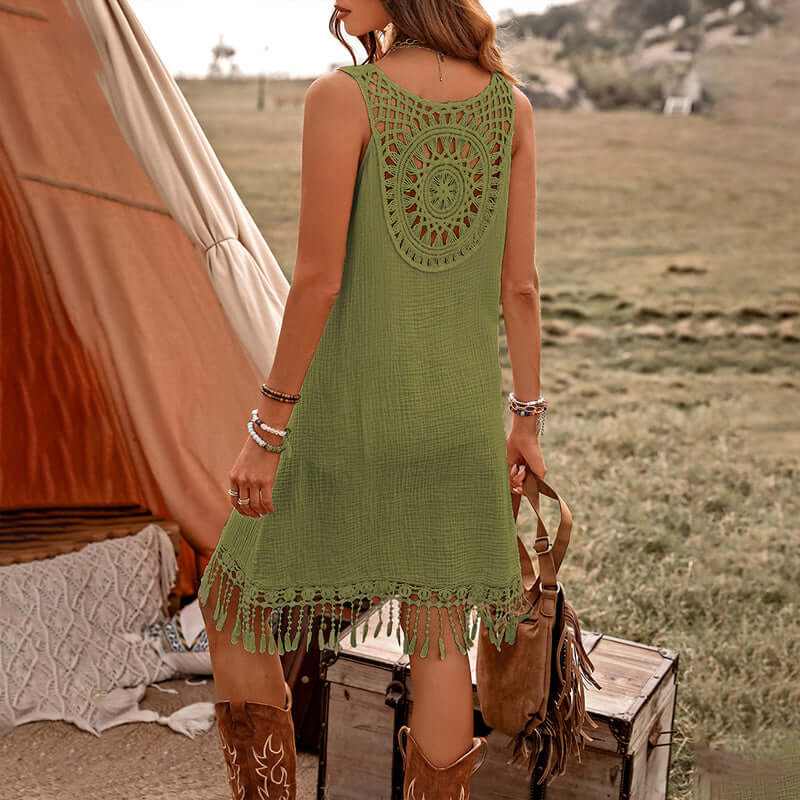 Back view of a woman in a green boho dress with fringe details, perfect for summer style and festivals.
