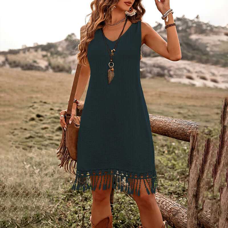 Women's solid color boho dress with V-neck and fringe detail, perfect for summer style and comfort.