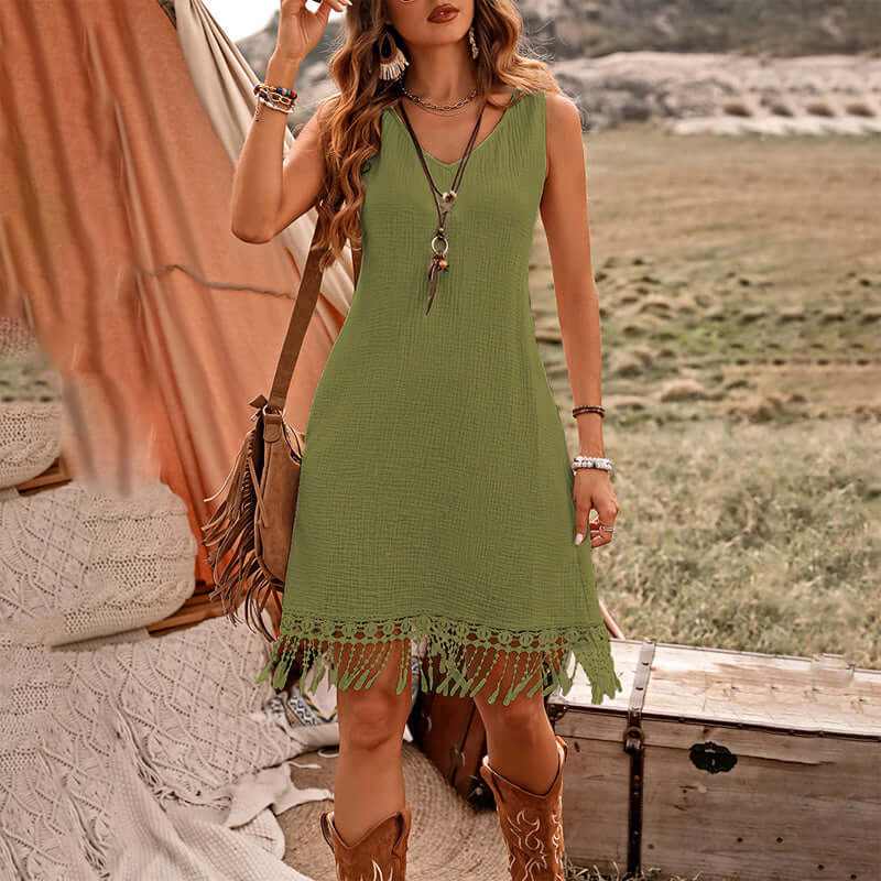 Women's boho dress in green with V-neck and fringe detail, perfect for summer outings.
