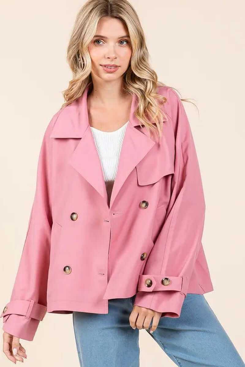 Elegant pink double-breasted trench coat jacket on a model, showcasing stylish design and versatility.