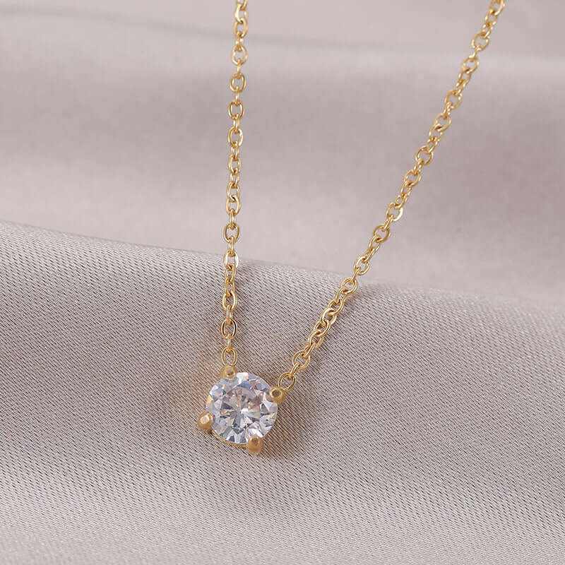 Elegant zircon birthstone necklace with a round solitaire zircon centerpiece on a gold chain.