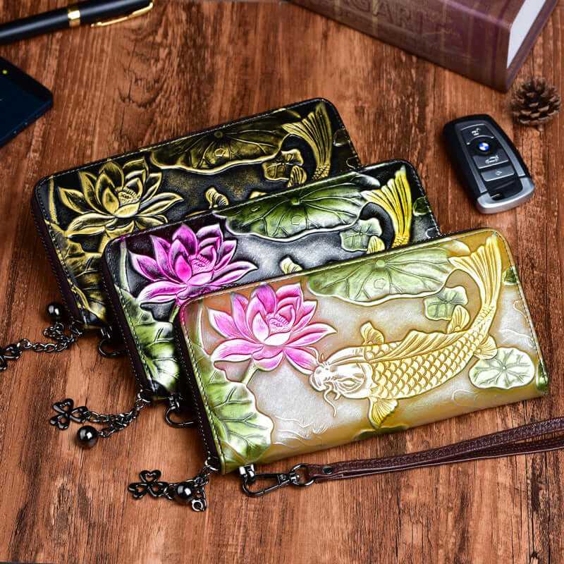 Embossed vintage women's cowhide leather wallets featuring lotus and koi designs in various colors.