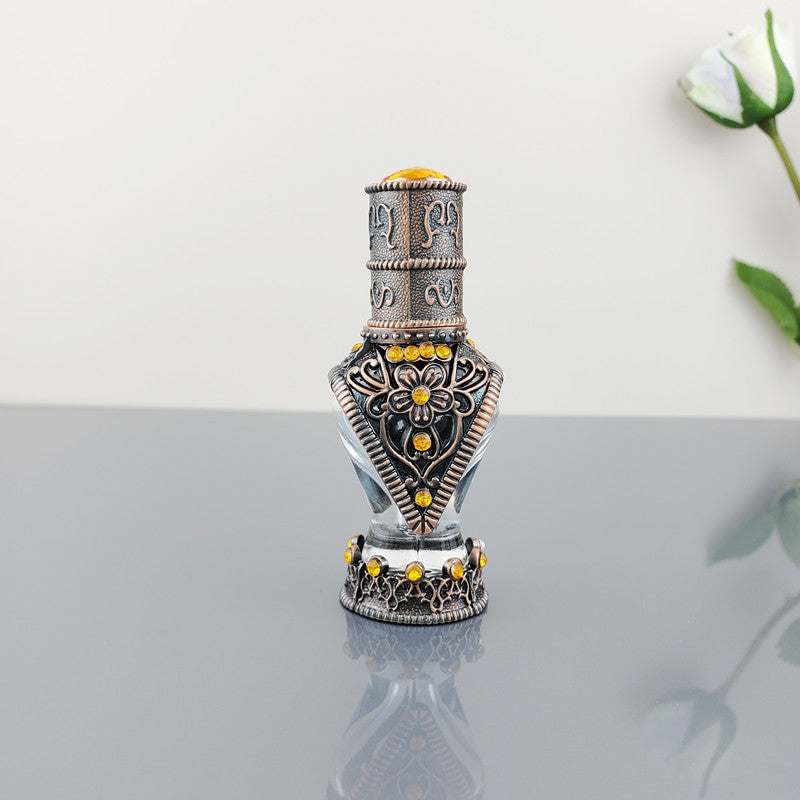 Decorative vintage cosmetic bottle with alloy and glass design and yellow embellishments