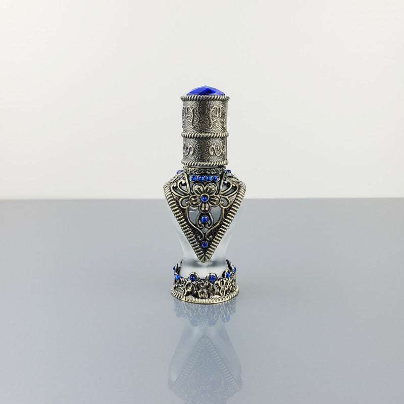 Decorative vintage cosmetic bottle with blue stones and alloy detailing