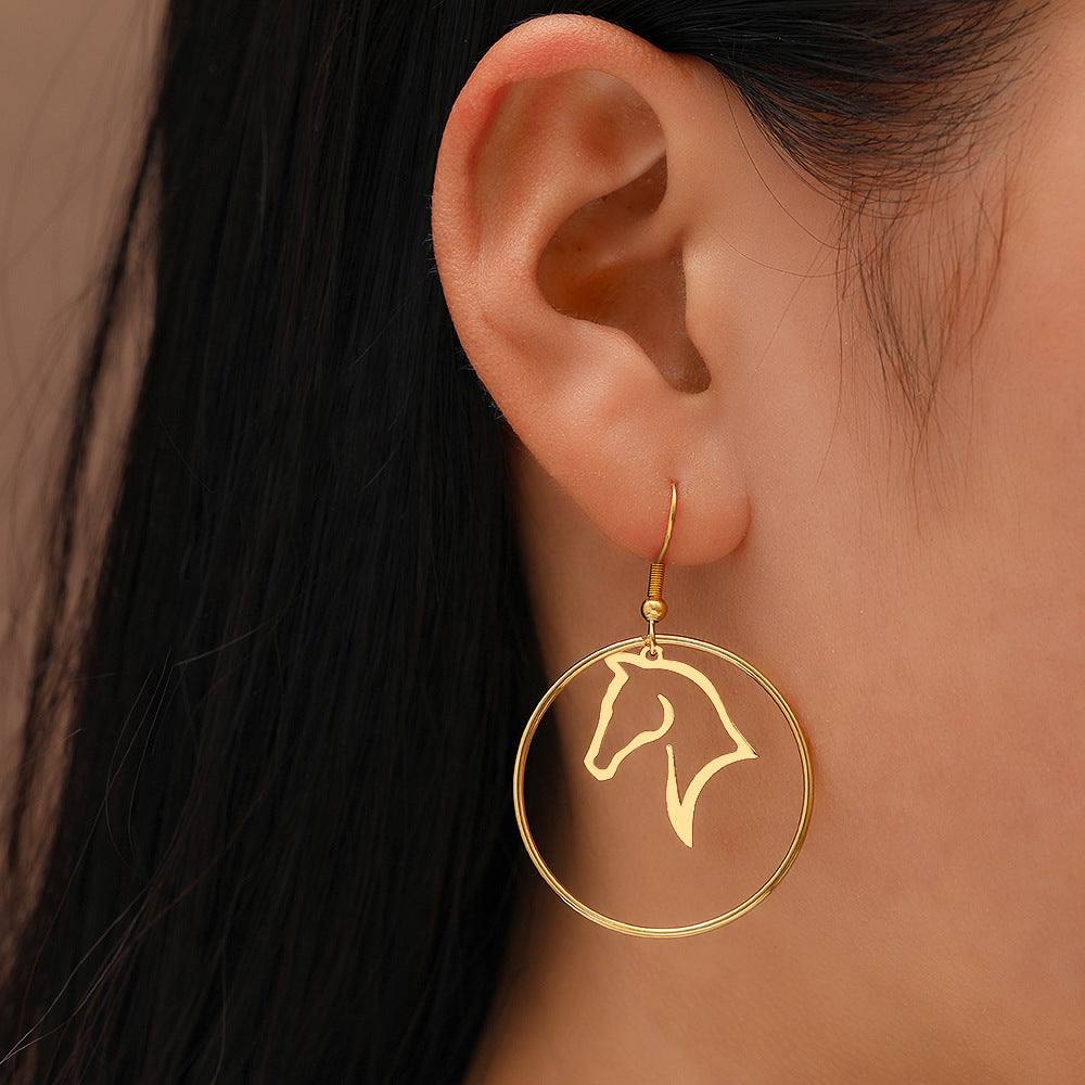 European and American minimalist stainless steel animal zodiac horse earrings shown on ear