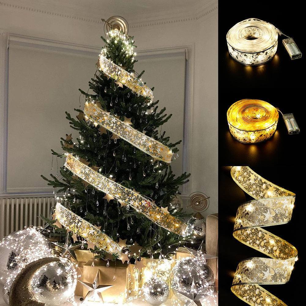 Christmas tree decorated with fairy lights ribbon bow tie and LED illuminated ribbon rolls