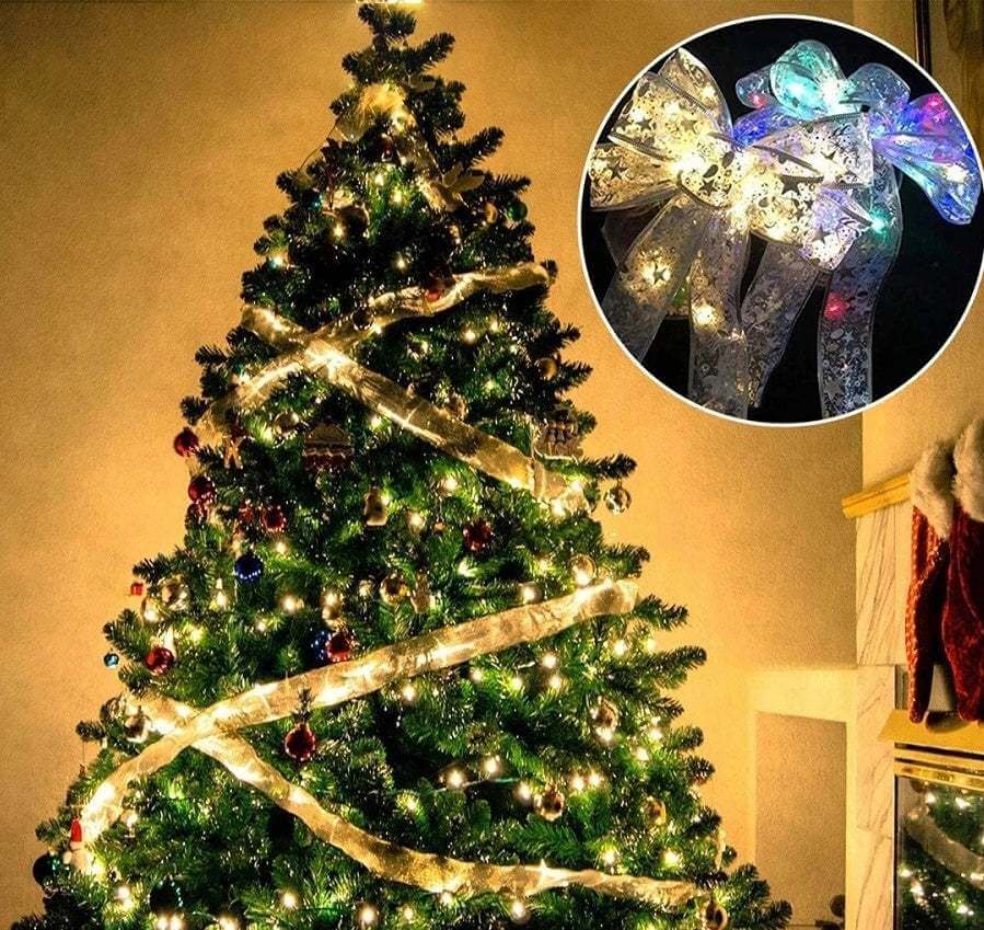 Christmas tree decorated with fairy lights ribbon bow tie and colorful LED bows