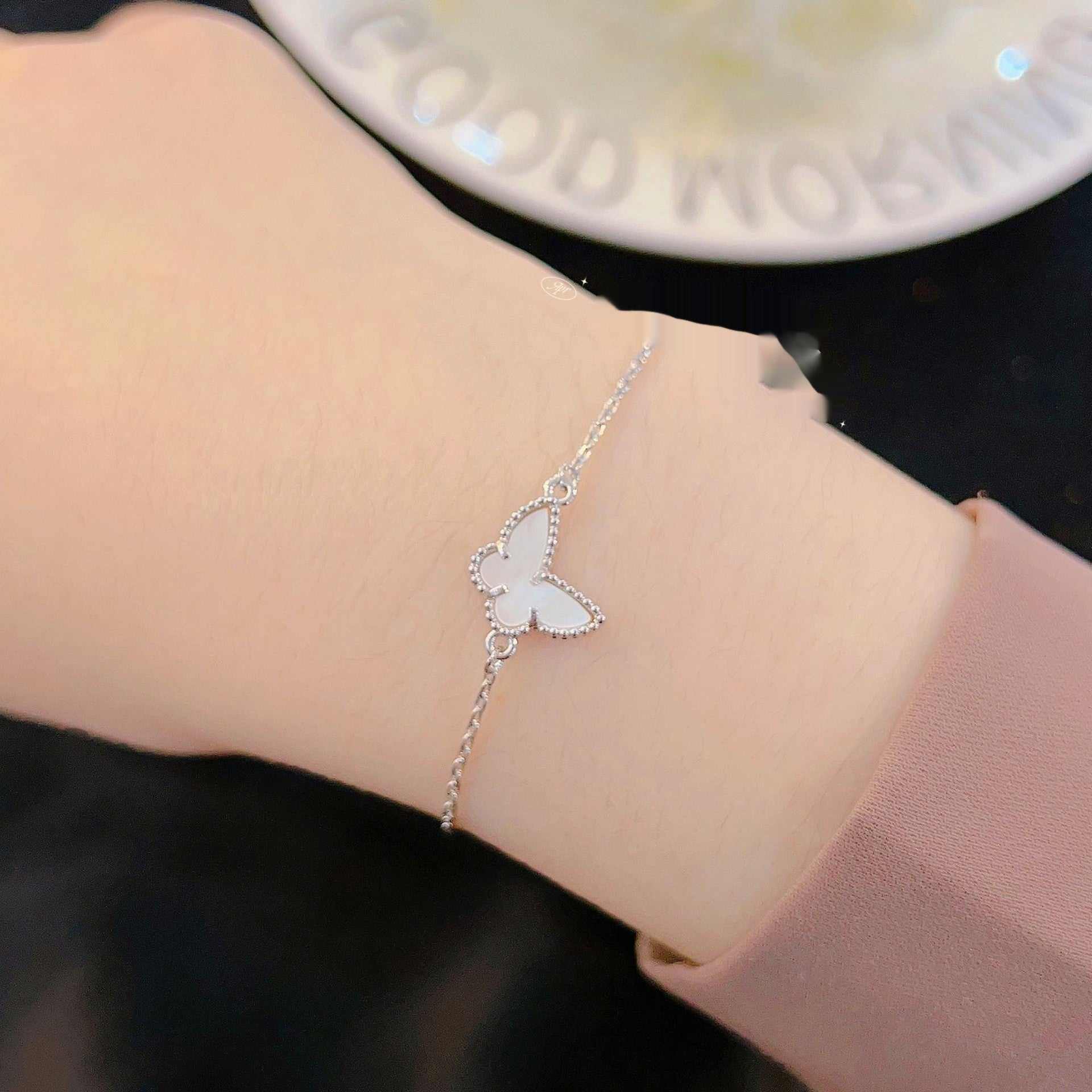 fashion blue turquoise bracelet with white shell butterfly charm on wrist