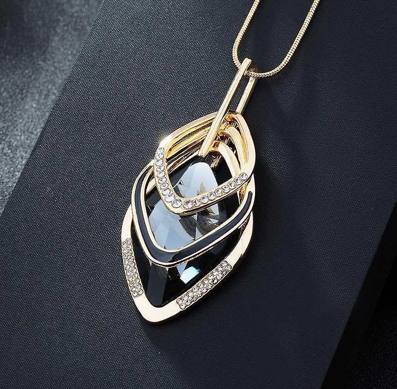 Fashionable layered long necklace with gold alloy and water drill pendant on black background
