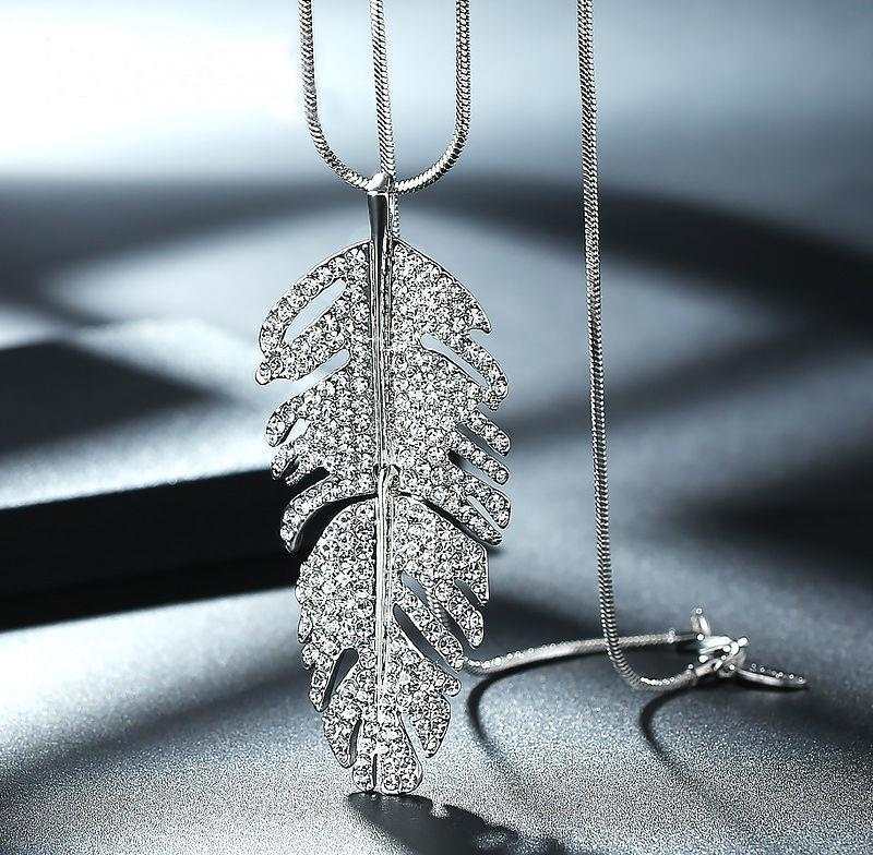 Fashionable layered long necklace with sparkling crystal feather pendant and silver alloy chain