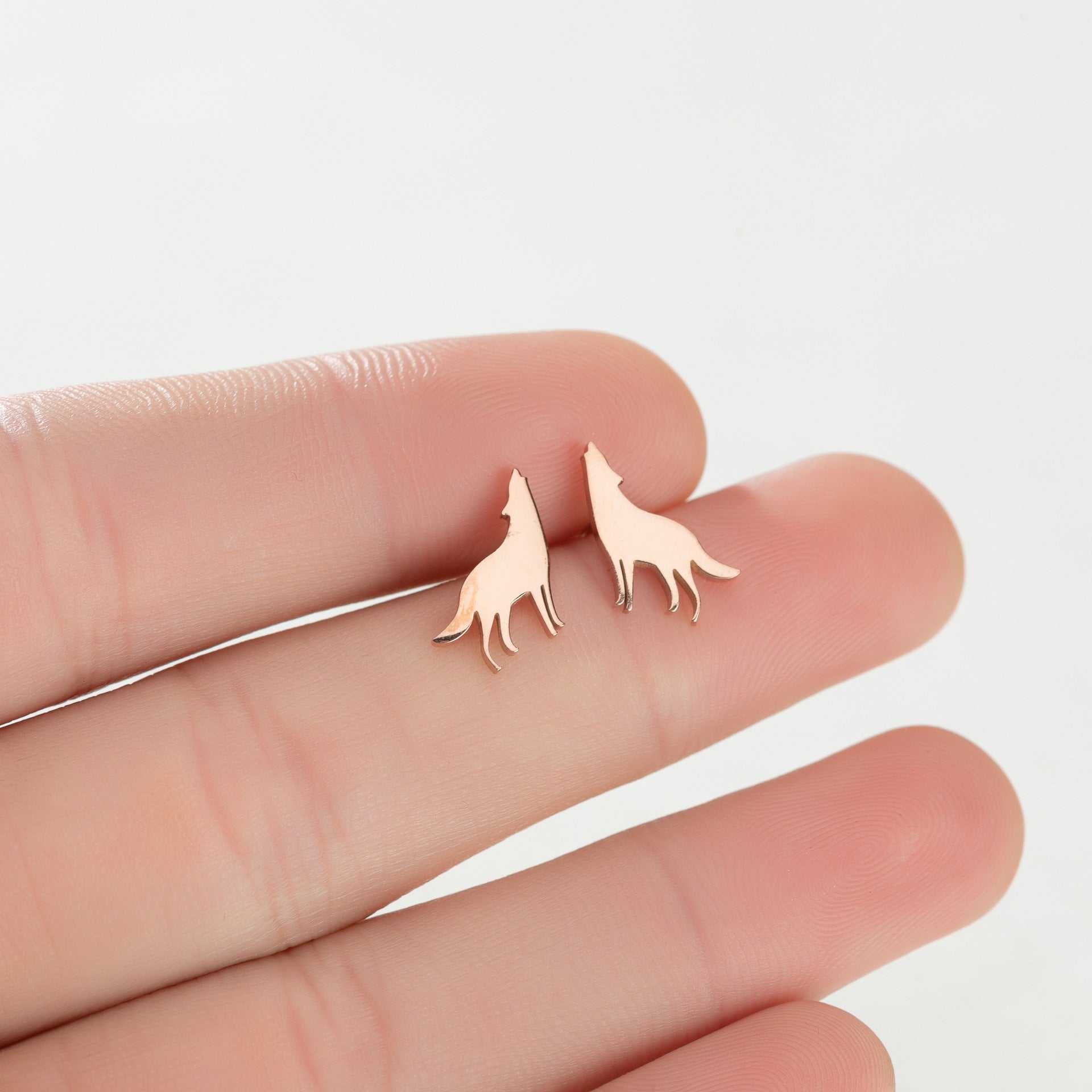 Female Japan and South Korea cute small animal ear studs in rose gold on fingers