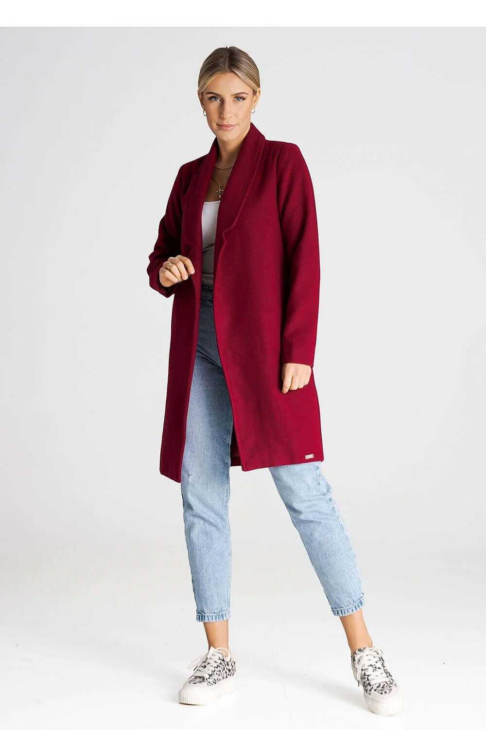 Model wearing Figl Women’s Longline Winter Coat in burgundy, styled with casual jeans and sneakers.