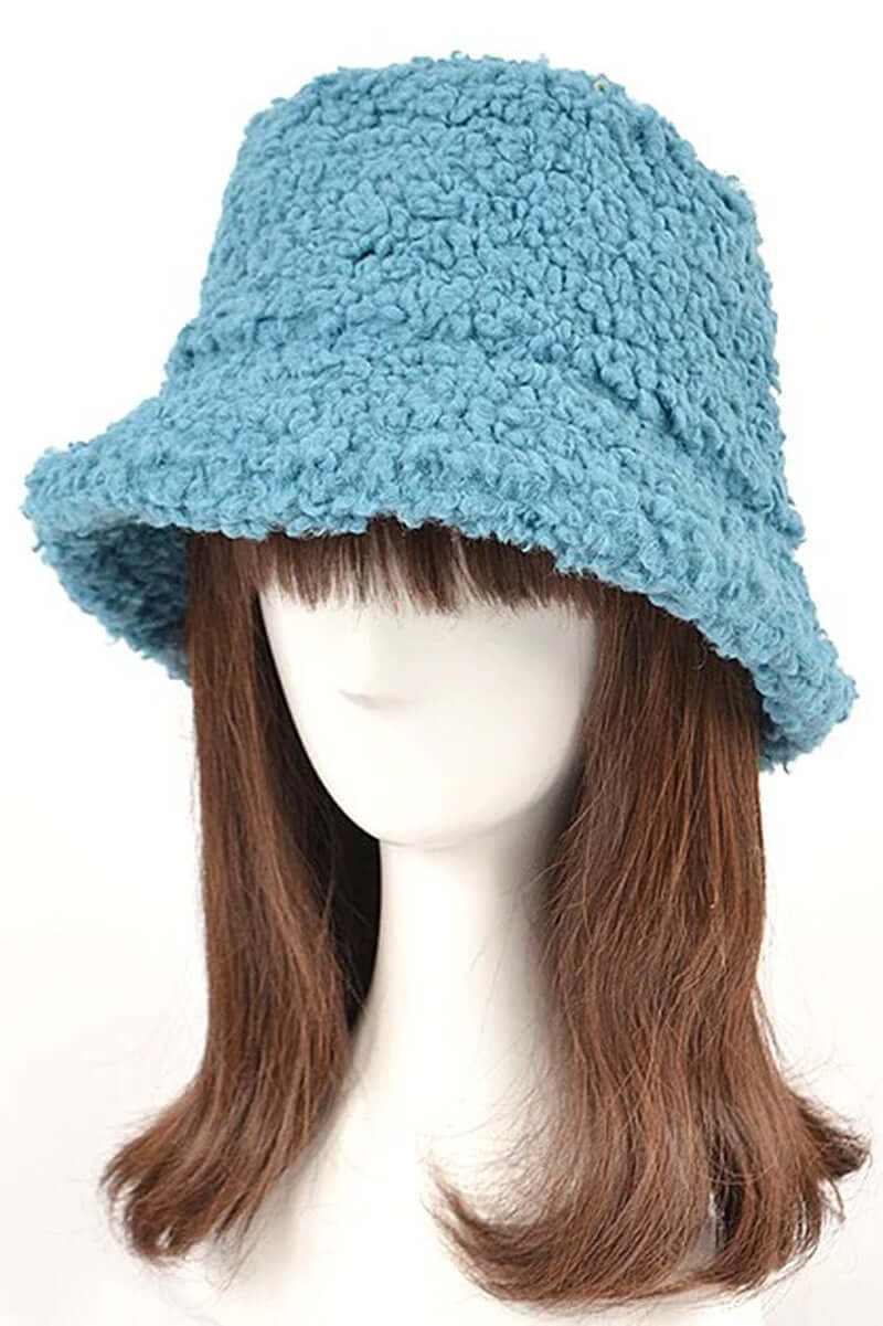 Fluffy shearling faux fur bucket hat in soft blue displayed on a mannequin with brown hair.