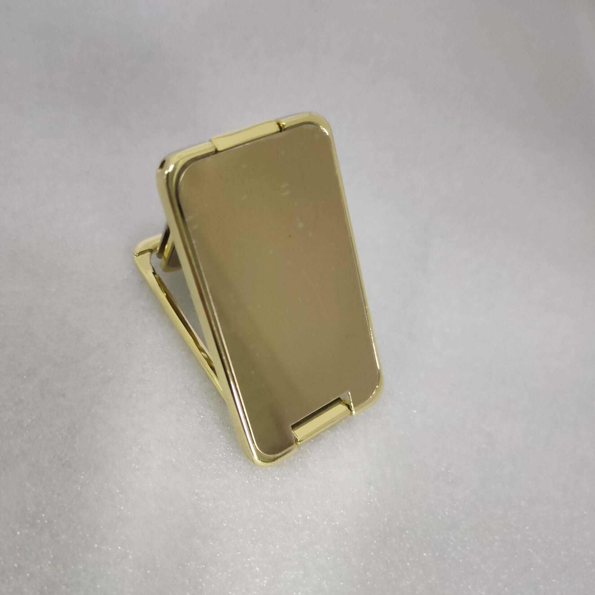 Foldable mobile phone holder in gold color, adjustable stand for smartphones and mini tablets.