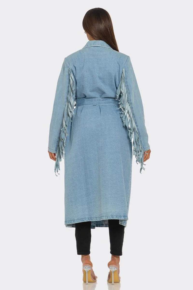 Back view of a fringed longline denim trench coat with a waist-cinching belt and layered detailing.
