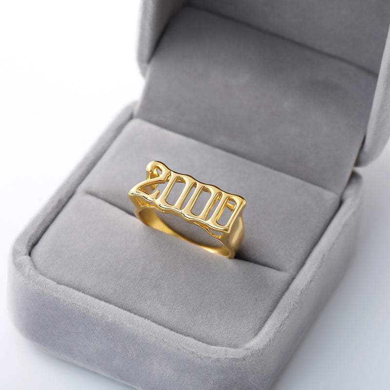 Gold futuristic and vintage cyberpunk style stainless steel ring with "2000" design in gray velvet box