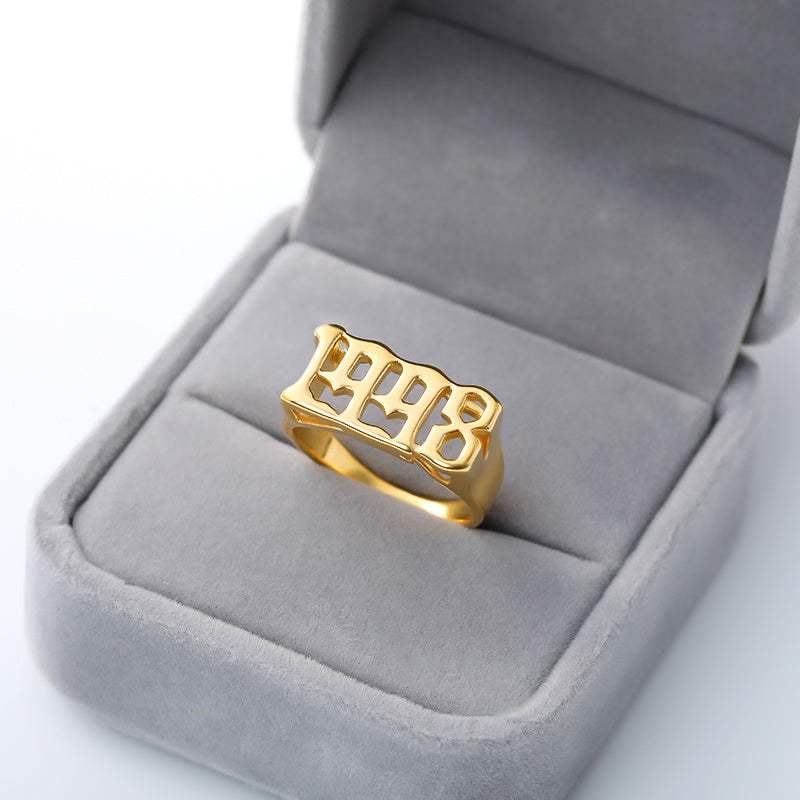 Gold stainless steel futuristic and vintage cyberpunk style ring with number cutout design in a gray velvet ring box