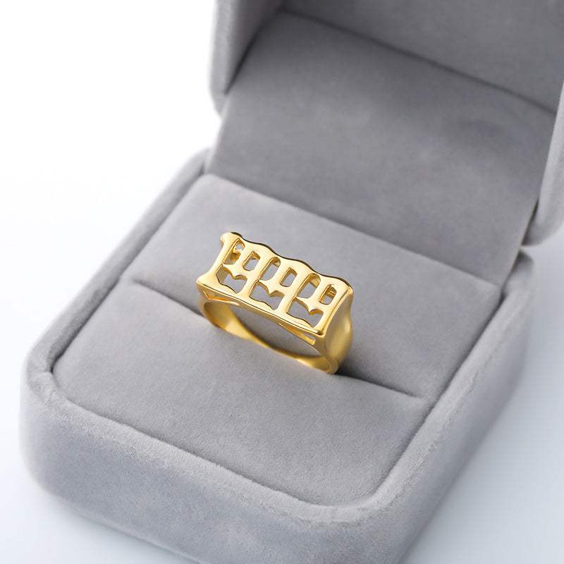 Gold futuristic and vintage cyberpunk style stainless steel ring with characters in gray velvet box