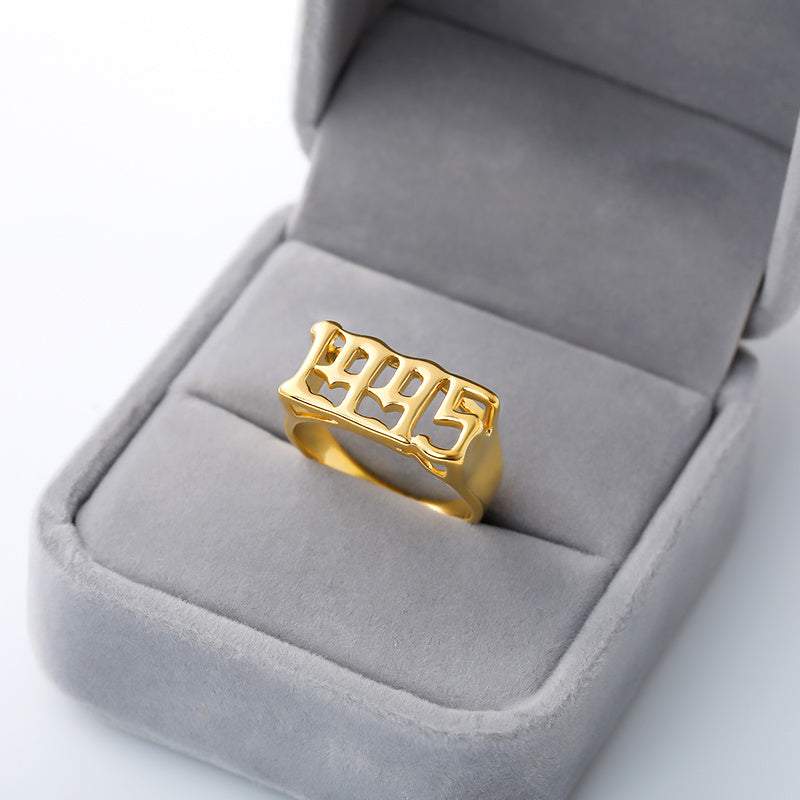 Futuristic and vintage cyberpunk style gold ring with number design in gray velvet box