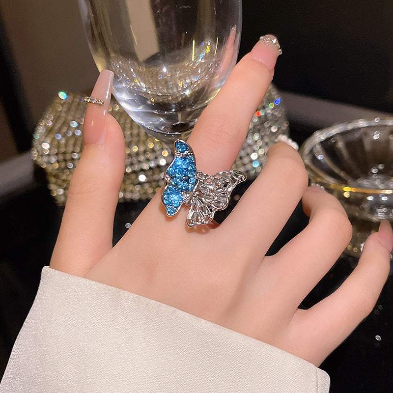Glamorous ethnic-inspired butterfly crystal ring in silver on woman's hand